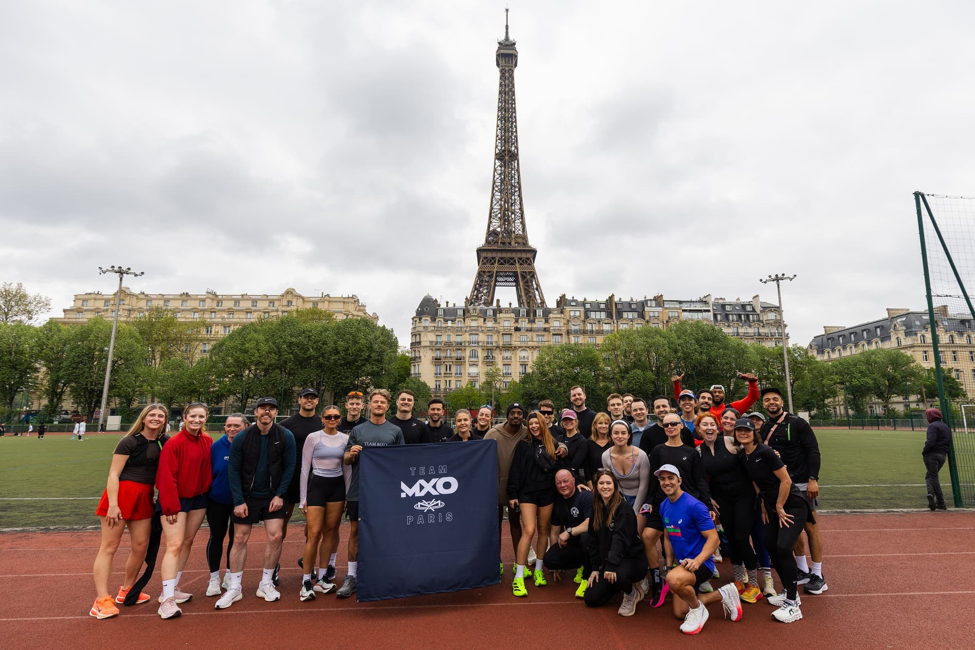 The MXO Paris Marathon team beneath the Eiffel Tower