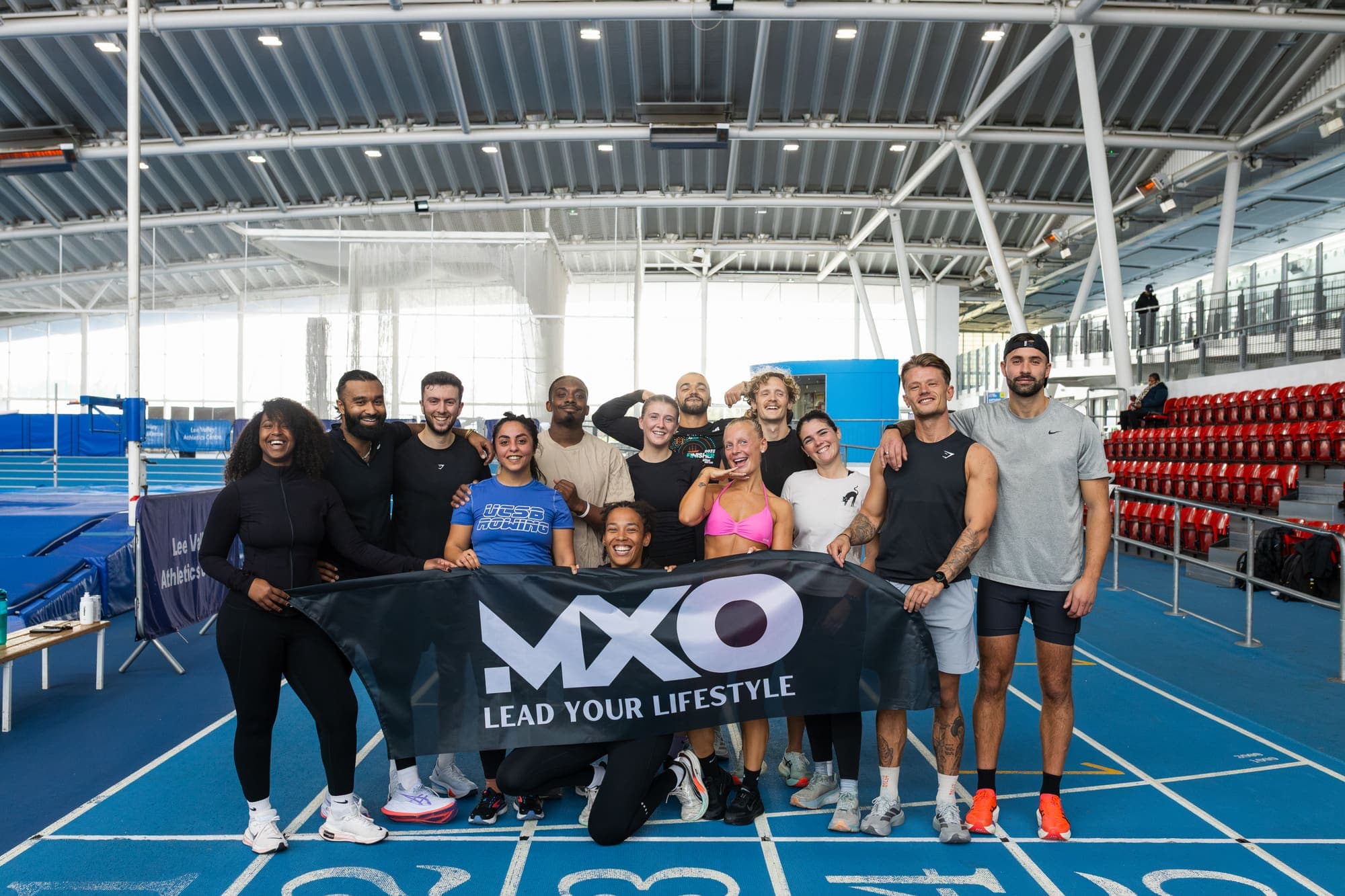 The MXO team together on an athletics track