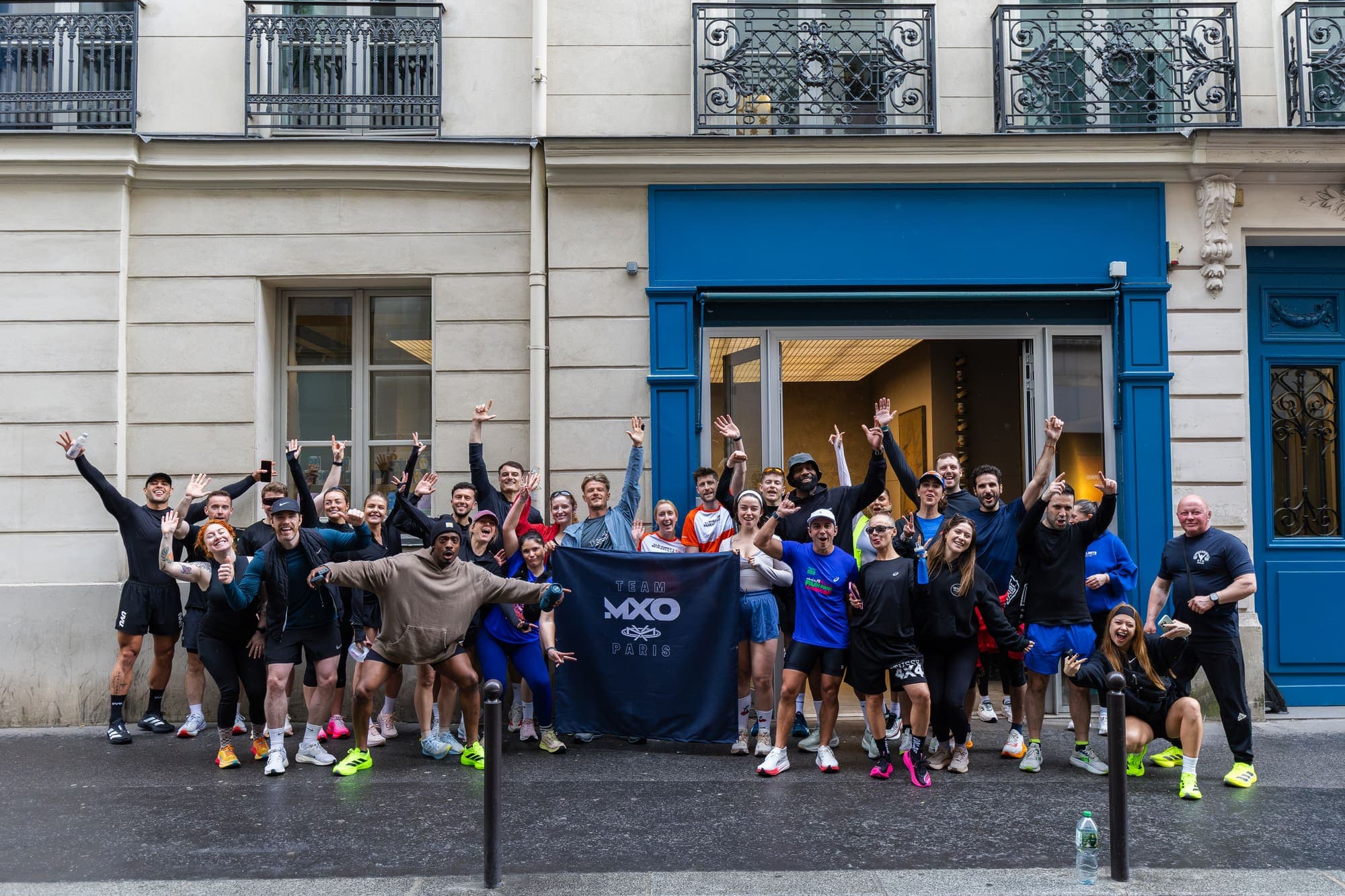 The Team MXO Paris group celebrating together on a Paris street before the marathon