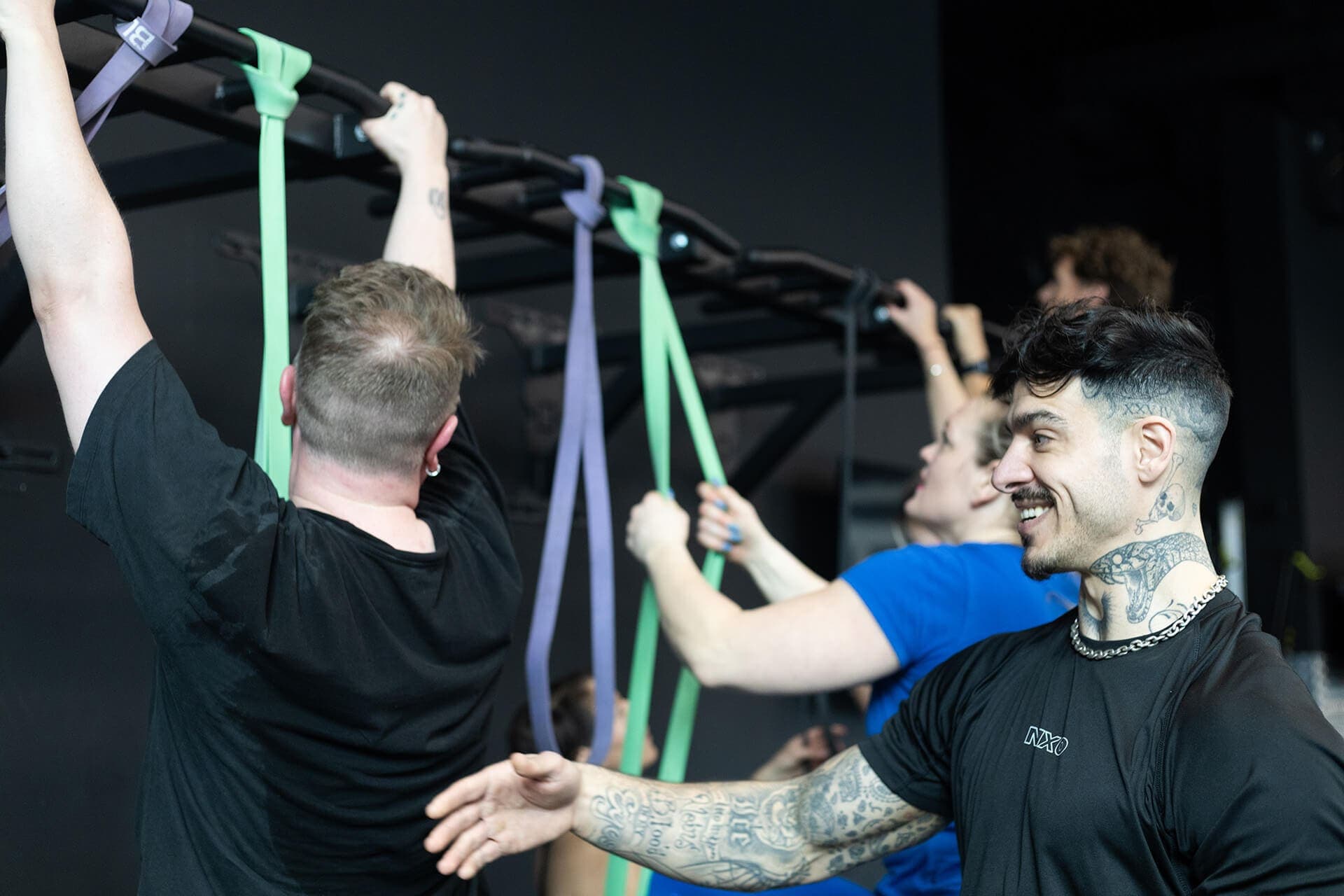 A coach working with participants on resistance bands during a group session